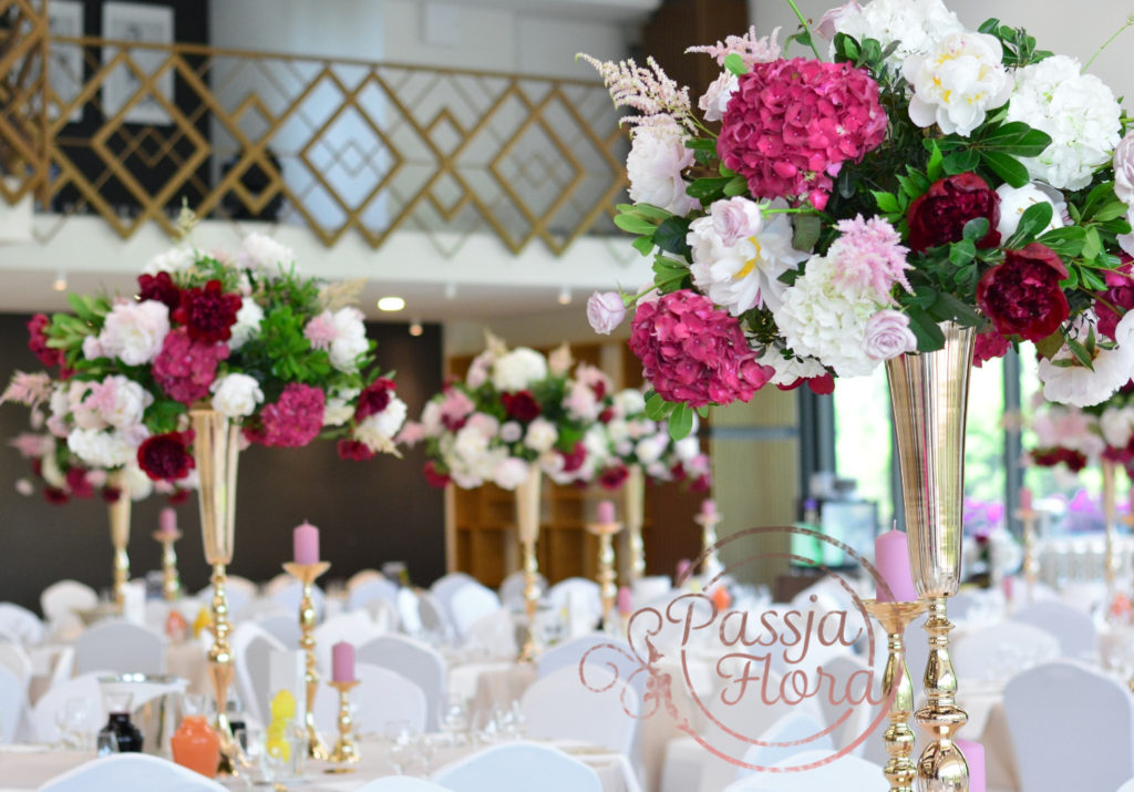 kwiatowe dekoracje na sali weselnej 